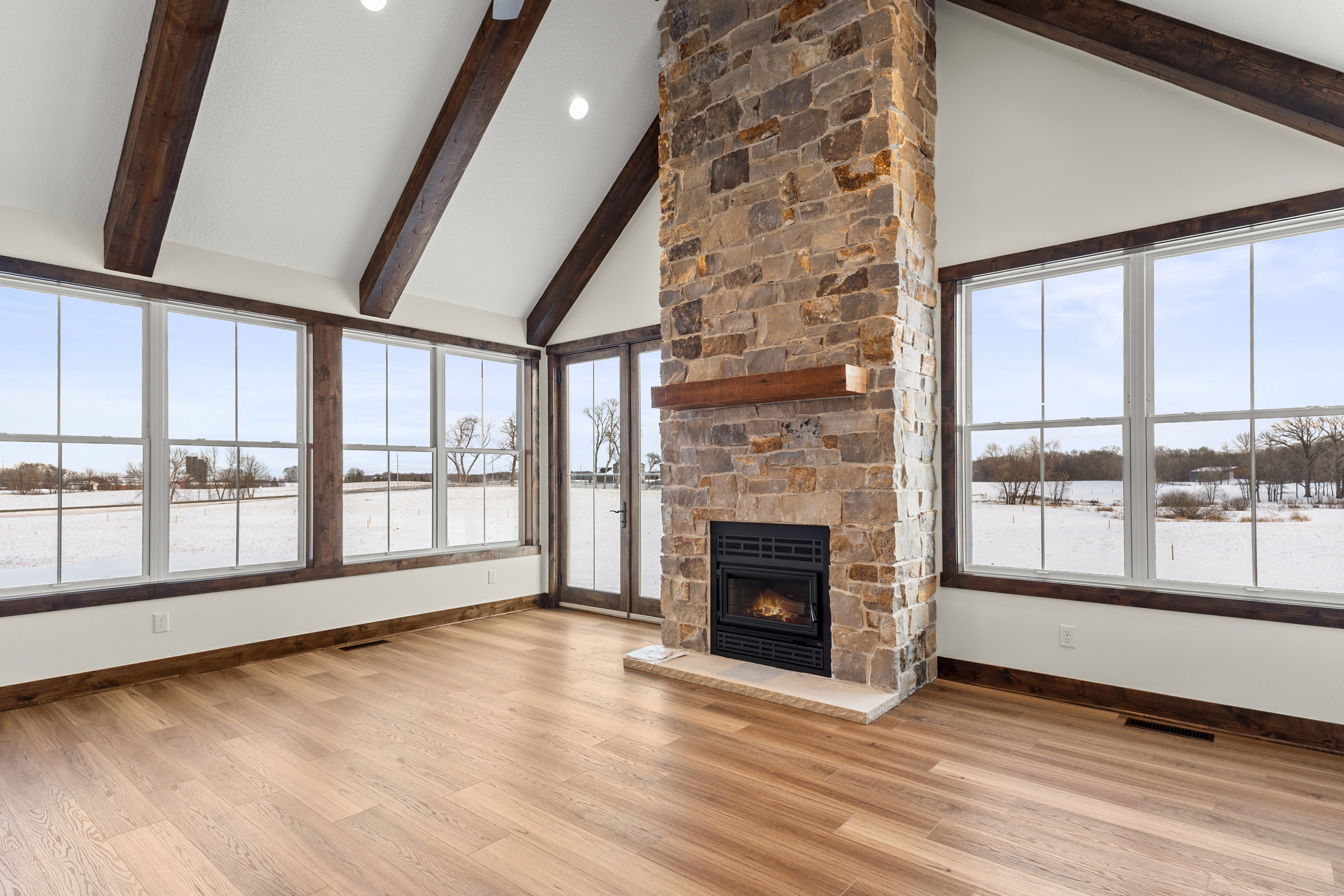 The Generations — great room with floor-to-ceiling stone fireplace
