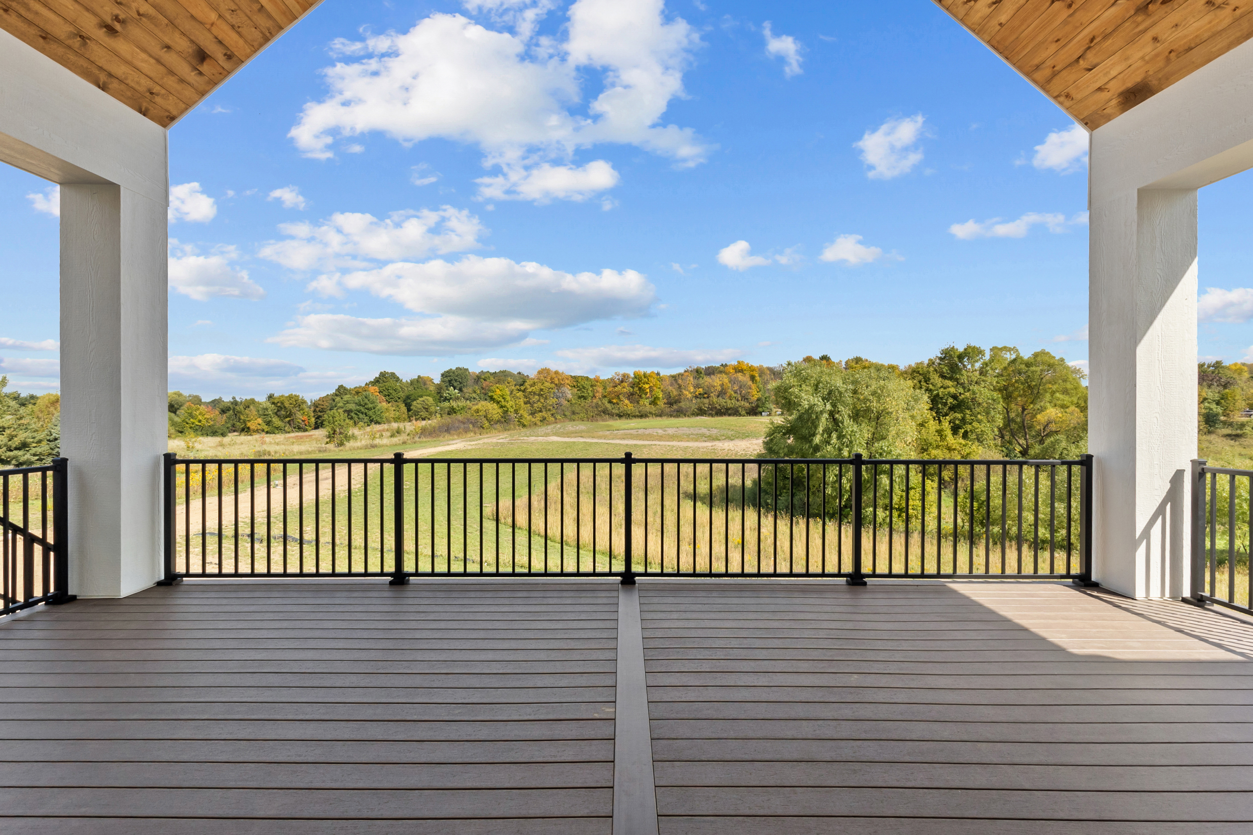 Covered deck overlooking rolling countryside — The Hearthwood