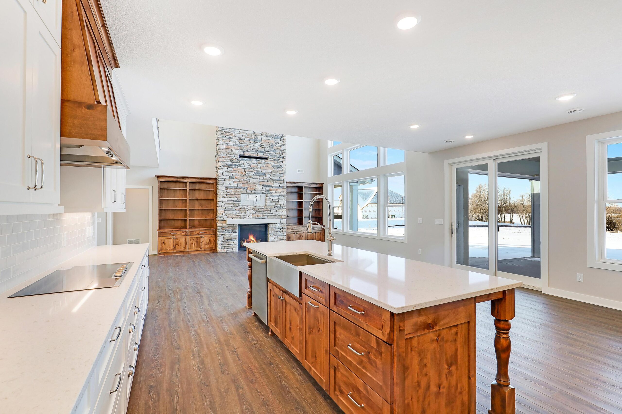 Open kitchen and great room with stone fireplace — The Outrider