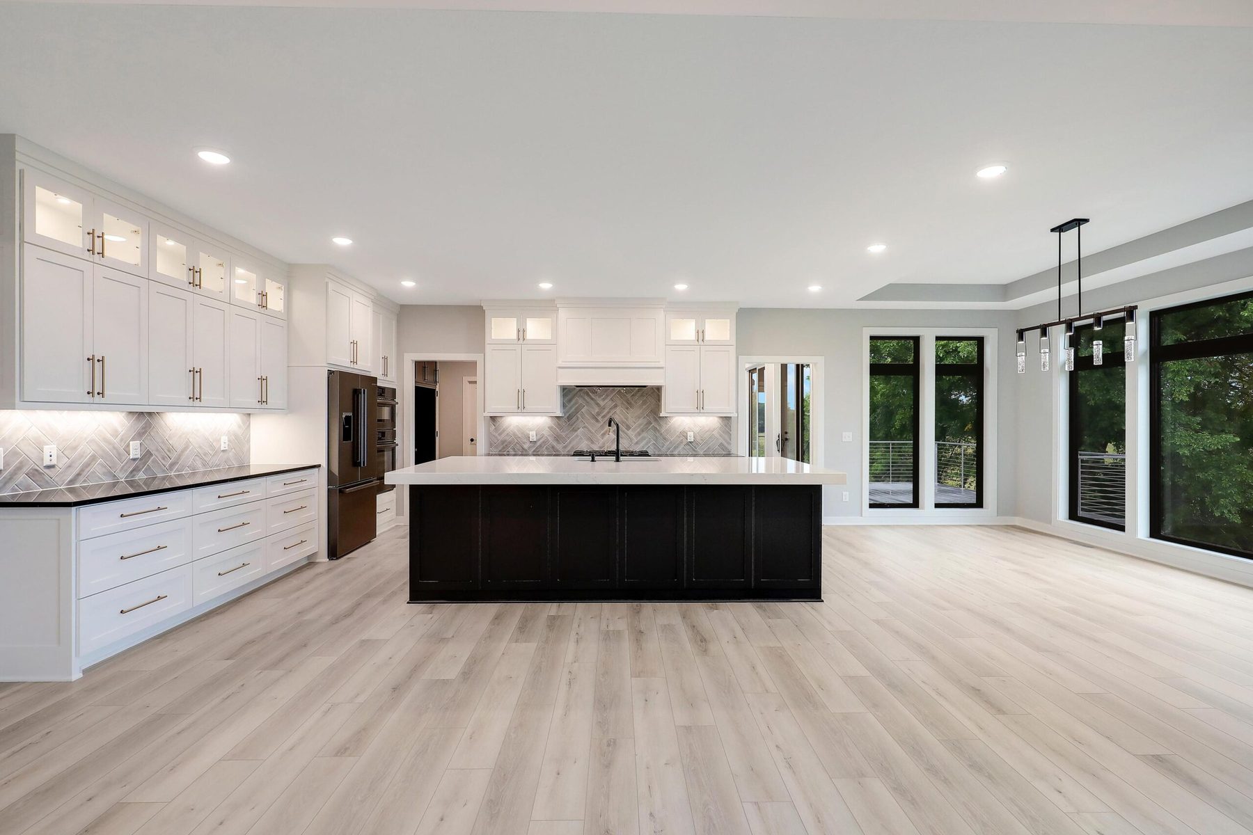 Screened porch with a stone fireplace and prairie views — The Rambler