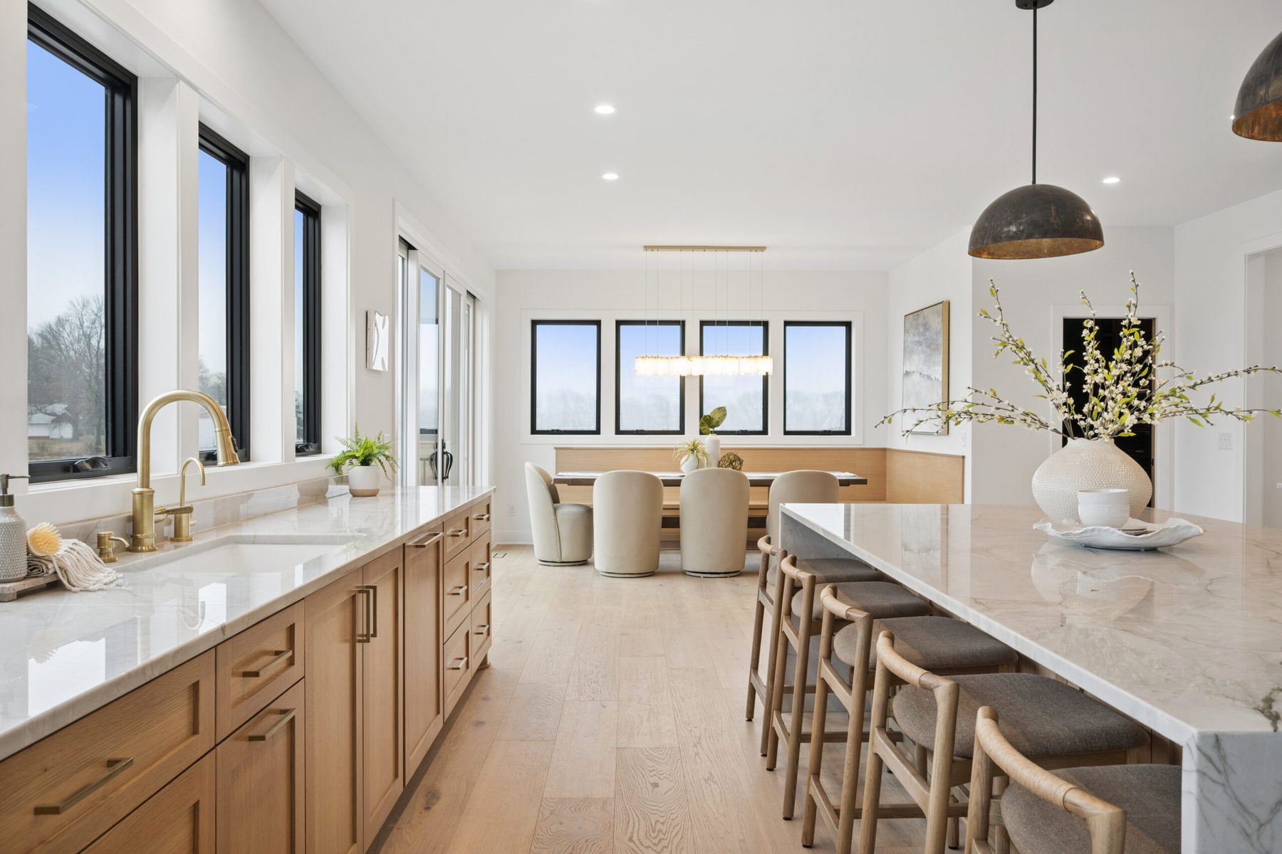 Light-filled kitchen and dining with banquette seating — the 2026 Spring Parade home
