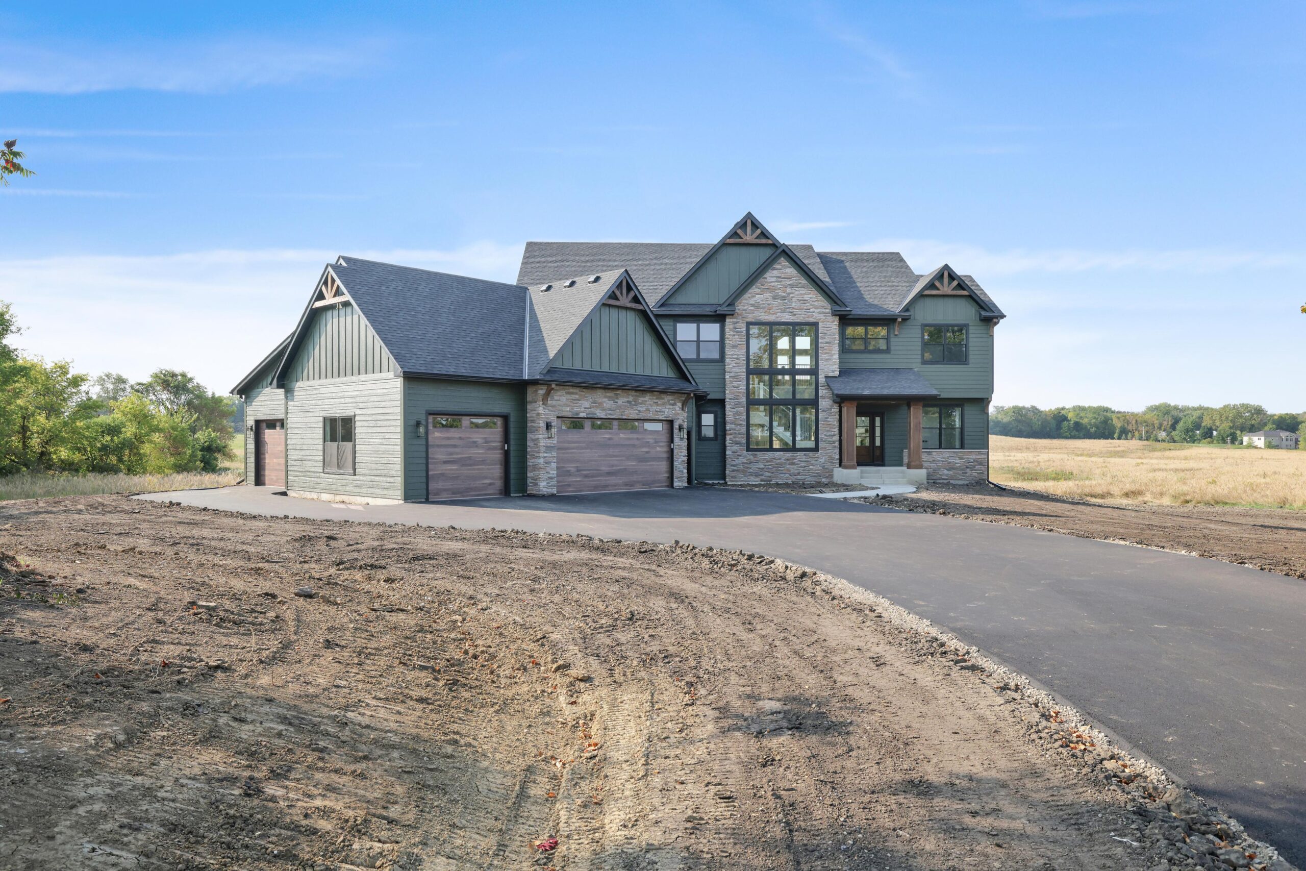 Sage-green modern farmhouse custom home on an open western Twin Cities homesite