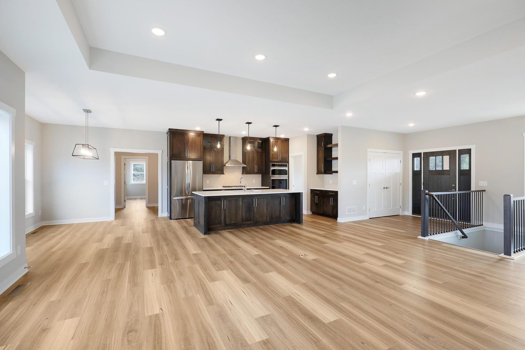 Open-concept living and kitchen with a walnut island — The Westfield